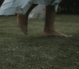 Close up of feet running on grass