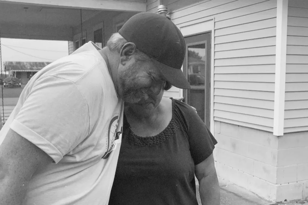 Man side hugging a woman