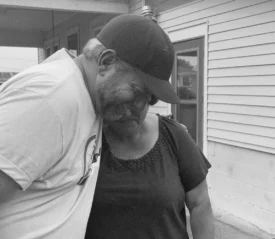 Man side hugging a woman