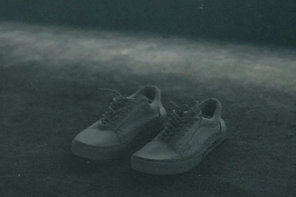 A pair of empty shoes on the ground