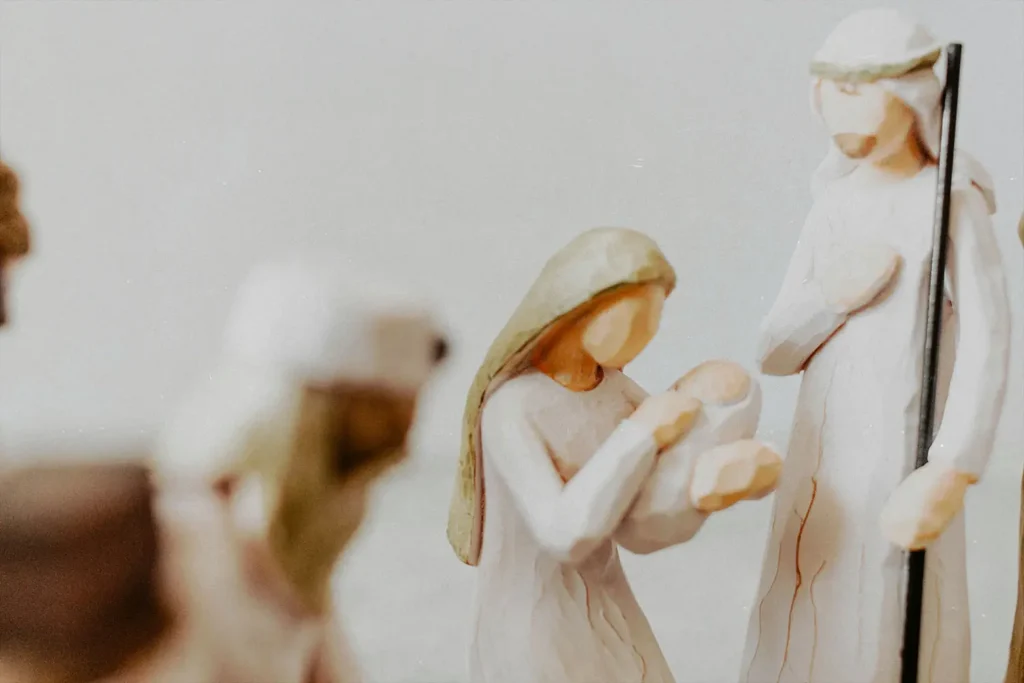 Wooden Mary and Joseph holding baby Jesus figurine