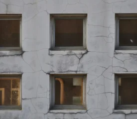 Six windows on a cracked cement building