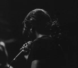 Woman holding a microphone worshipping