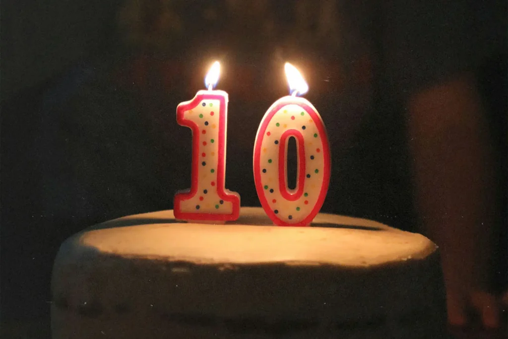 "10" candle lit on a cake