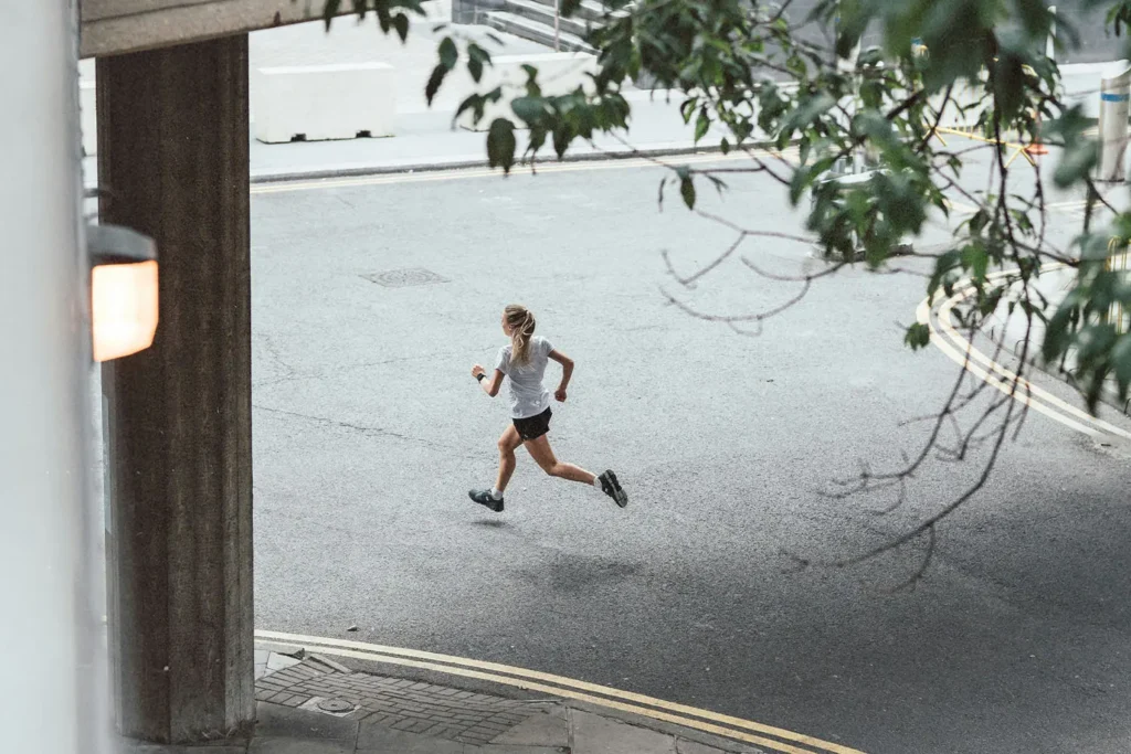 Window-view of girl running on the street
