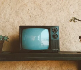 Turn dial box TV on a wooden shelf