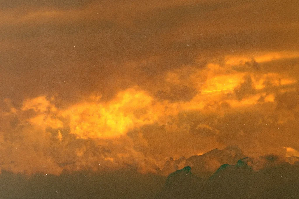 Dramatic sky filled with glowing orange clouds during a vivid sunset