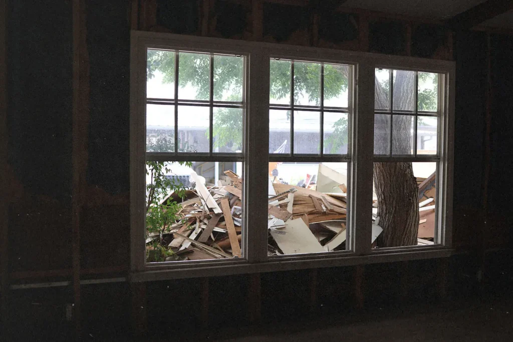 Open windows with a pile of construction scraps outside