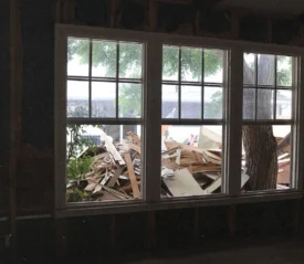 Open windows with a pile of construction scraps outside