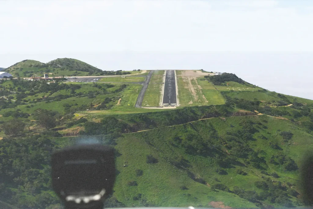Landing strip in a mountain surrounded by greenery