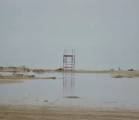 Metal scaffolding in the middle of sandy shore