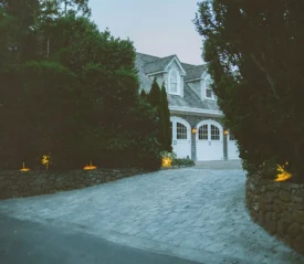 Driveway with trees leading to a garage
