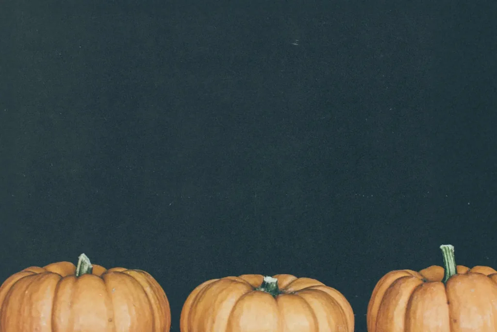 three pumpkins with black background
