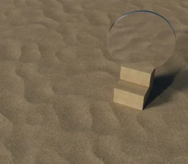 Round mirror placed on a small wooden block in the middle of textured sand, reflecting the surrounding sandy surface