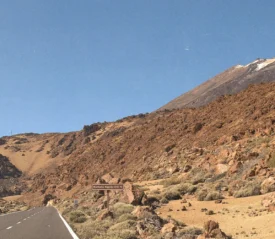 side of a rock mountain with a hint of the road