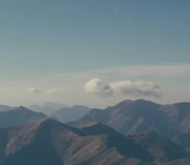 mountain range with a cloud above