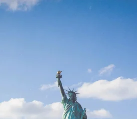 top of statue of liberty with clouds in the sky