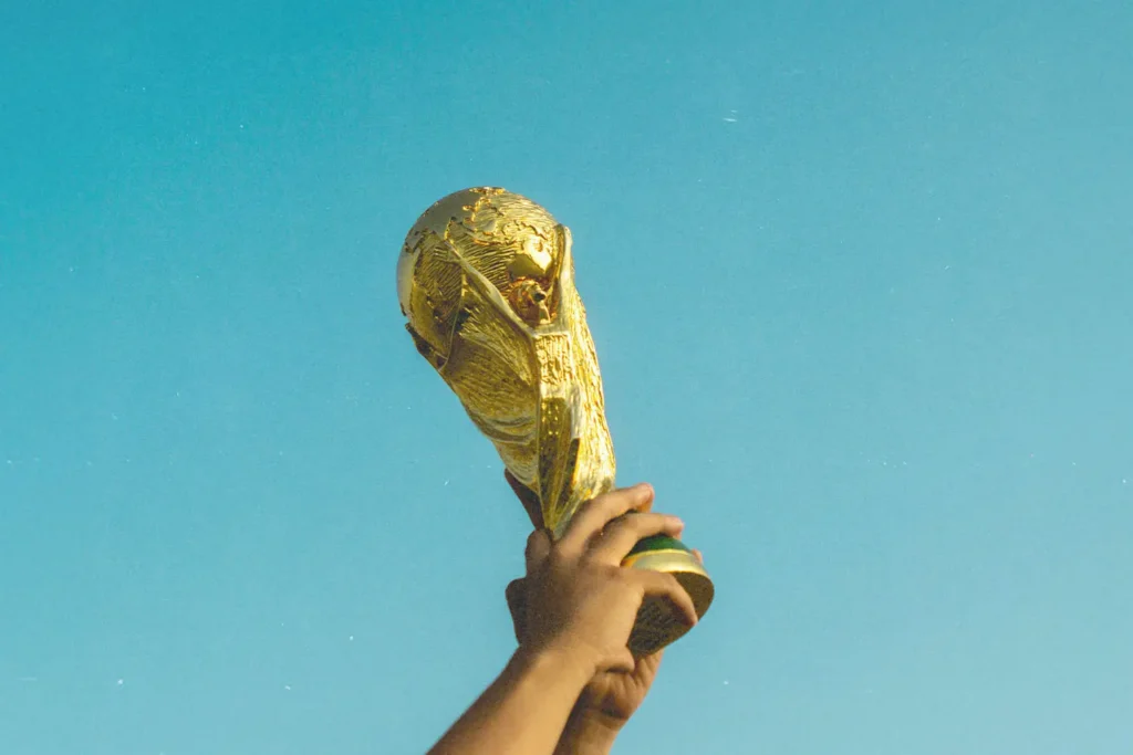 person holding up a trophy to the sky