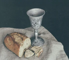 bread and goblet on napkin on a table
