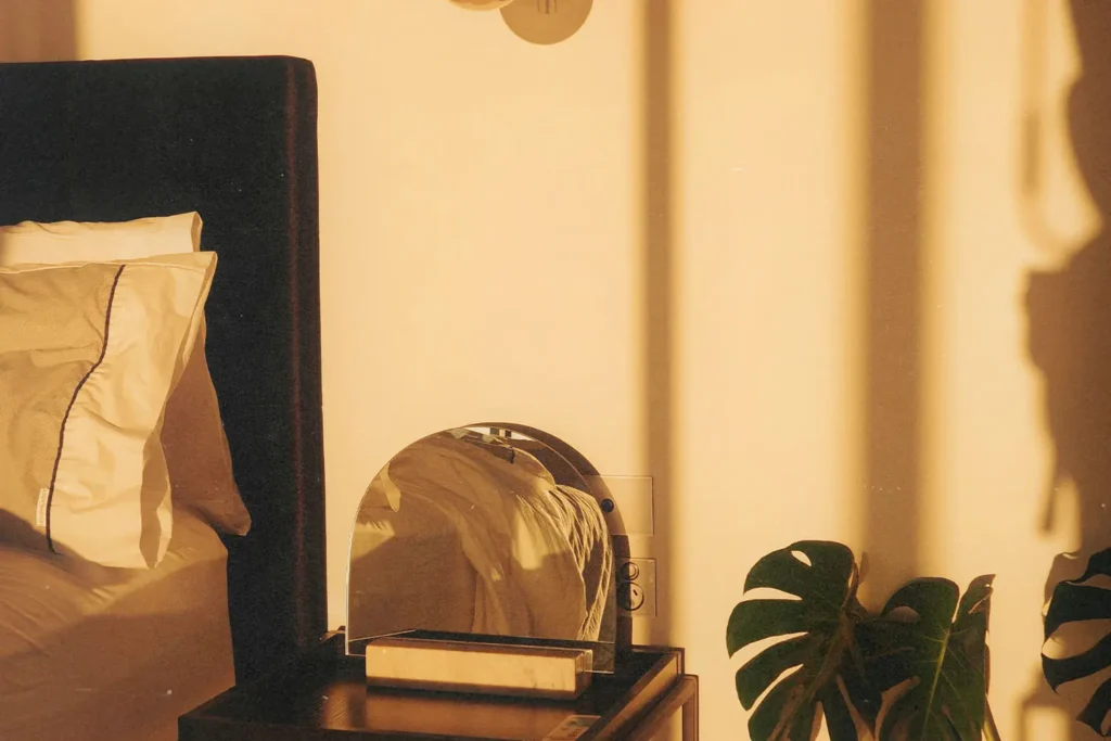 arched mirror on nightstand next to bed