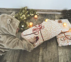 child playing with christmas gifts