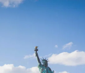 top of the statue of liberty and clouds in the sky