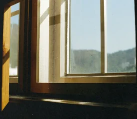 sun shining into a wooden window