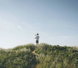 father holding his son in a field of grass