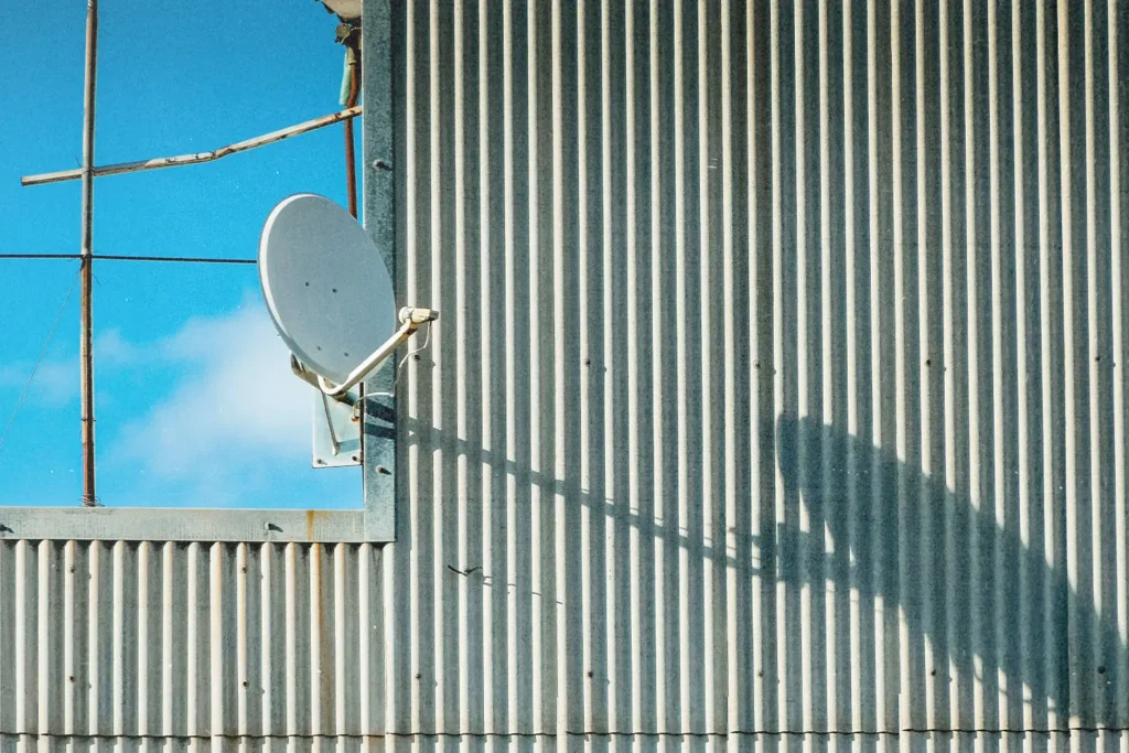 satellite dish on the side of a metal building
