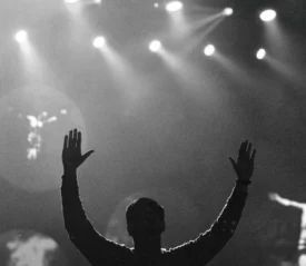 man worshipping Jesus with raised hands