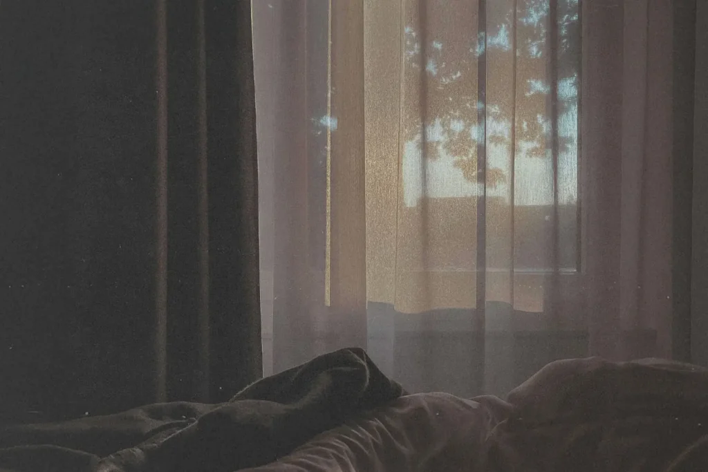 early morning light coming in through a curtained window