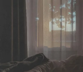 early morning light coming in through a curtained window