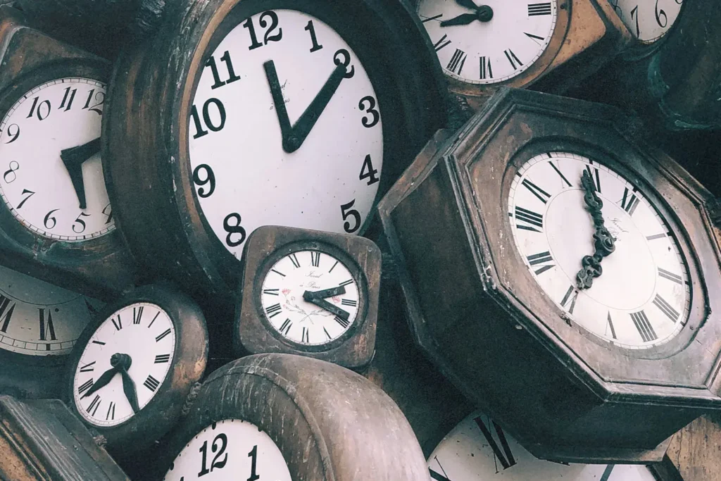stash of wooden analog clocks