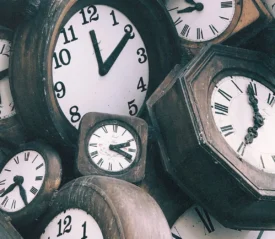 stash of wooden analog clocks