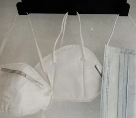 three hanging face masks