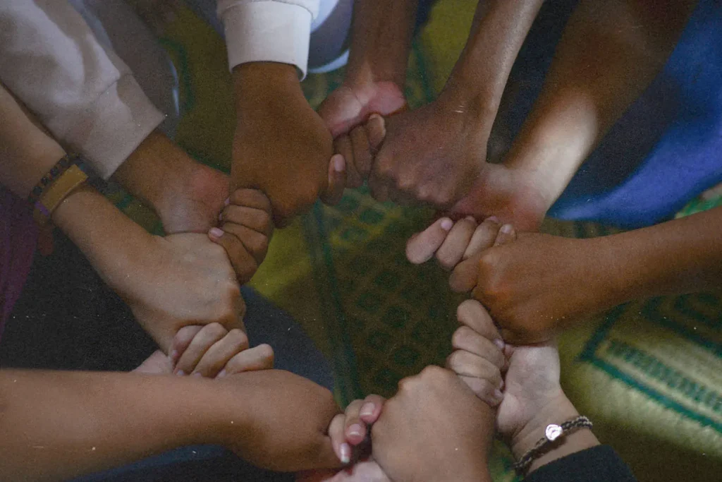 Group of hands holding to form a circle