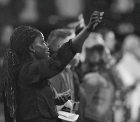 Woman standing with her hands lifted in praise