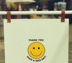 Hanging sign that reads "THANK YOU HAVE A NICE DAY!" with a yellow smiley face