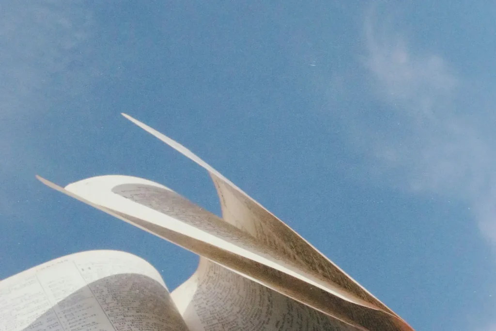 Open Bible pages turning by the wind