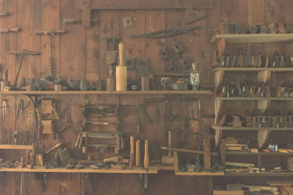 Wooden shed wall with shelves of carpenter tools