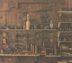 Wooden shed wall with shelves of carpenter tools