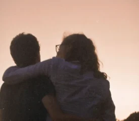 A couple with arms around each other