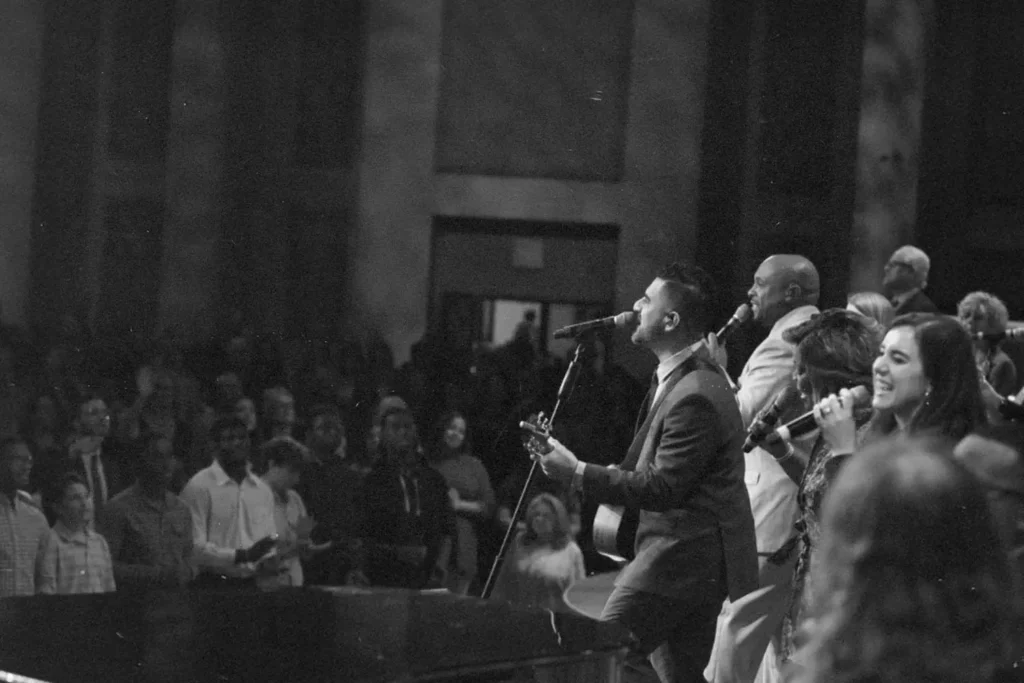 EMIC Worship team leading worship in front of congregation