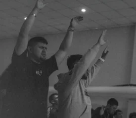 Two men lifting their hands in prayer