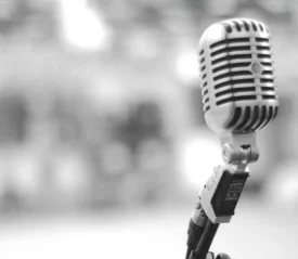 Vintage-style microphone on a stand with a blurred background