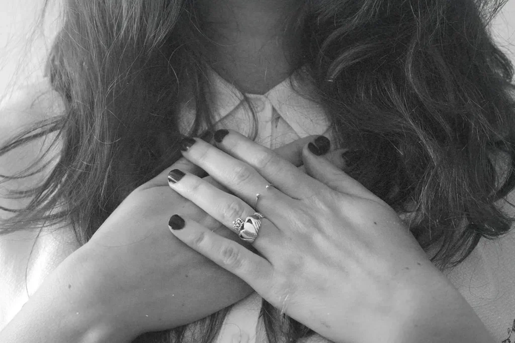 Two hands grasping sternum