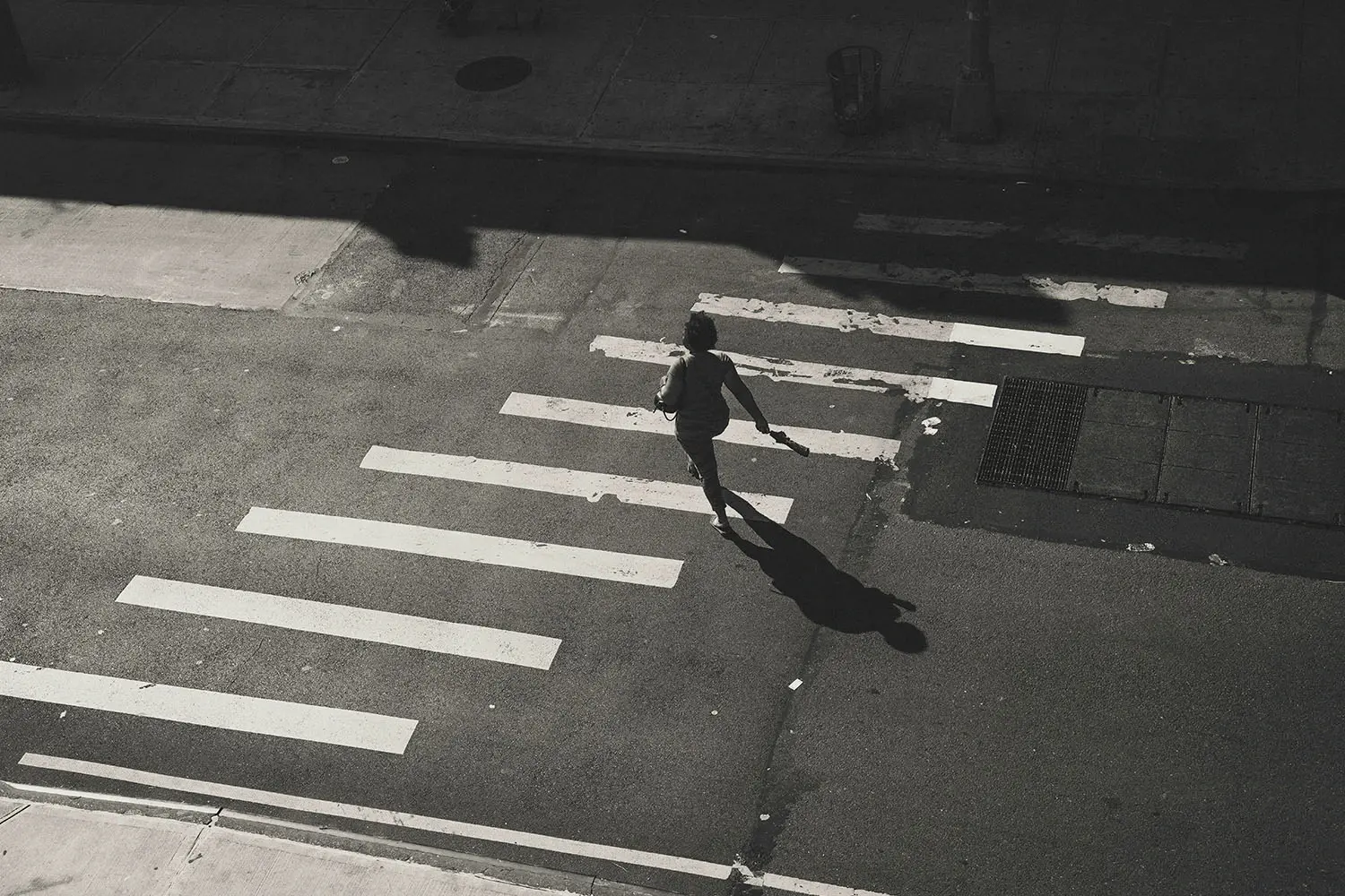 Aerial view of woman walking on crosswalk