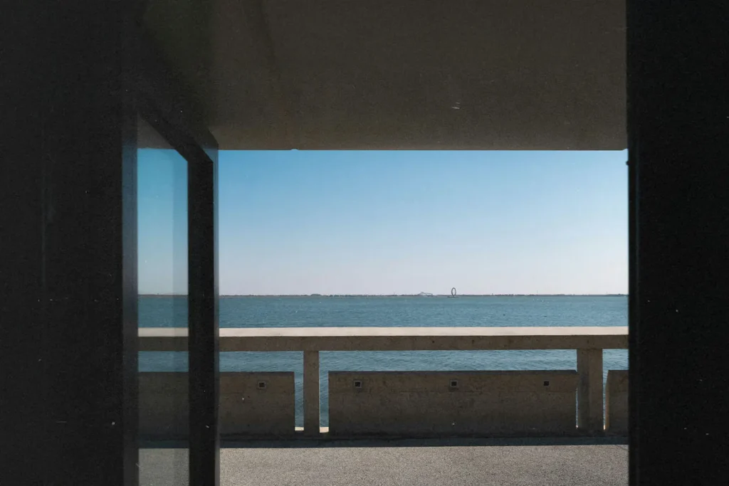 Open window with a view overlooking a pier on the water