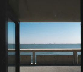 Open window with a view overlooking a pier on the water