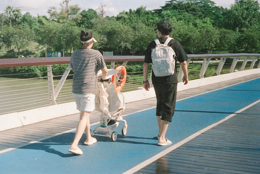 Couple walking pushing a baby carriage